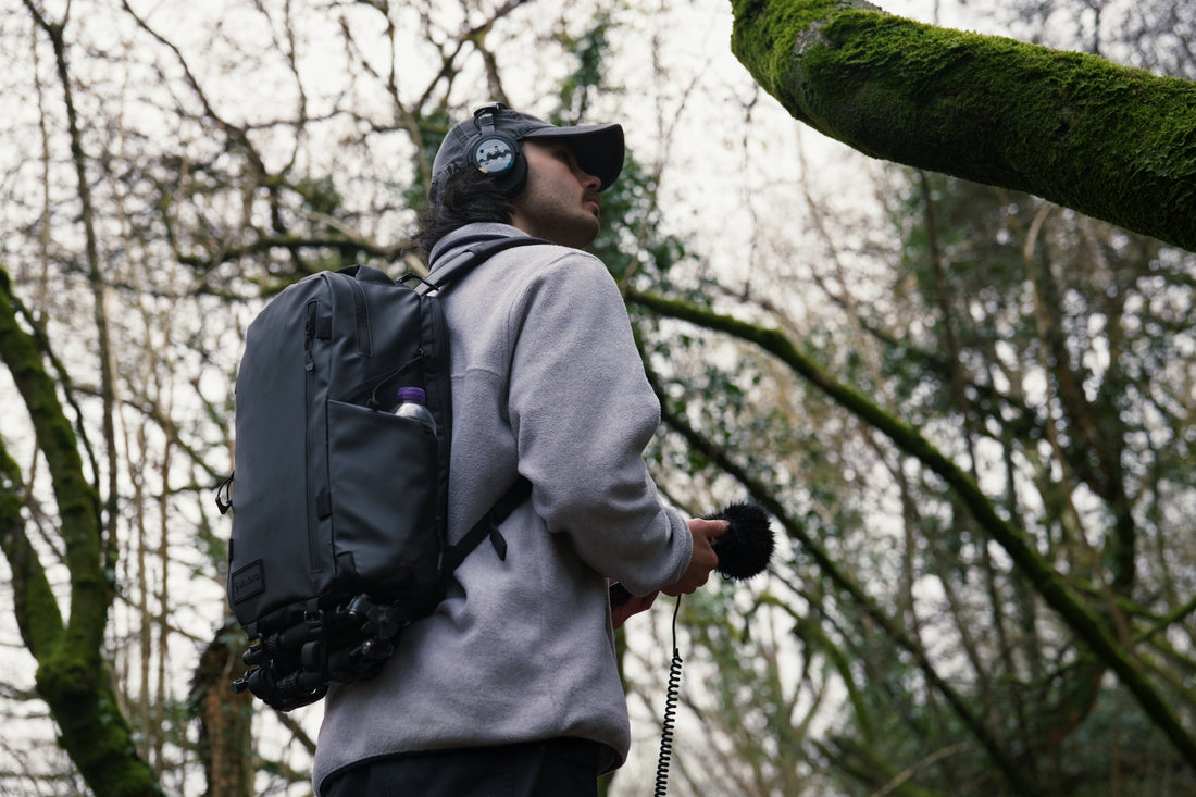 Content Creator in the woods wearing a WANDRD PRVKE Zip 21L Backpack